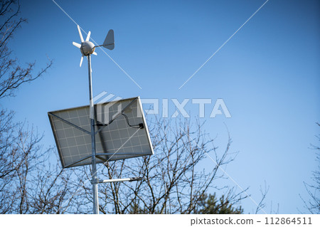 Solar batteries with a wind turbine to power led lamps. 112864511