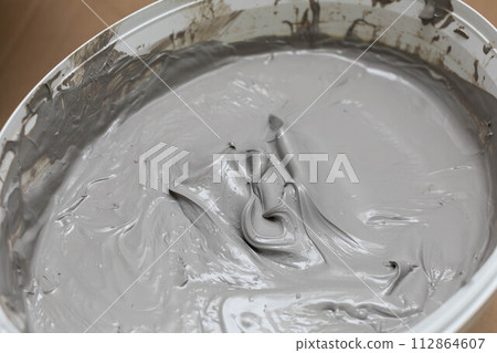 Open bucket full of moisture insulation. A container for a large amount of liquid substances. 112864607
