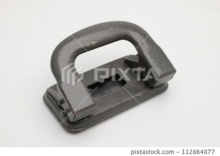 Stationery old hole punch on a white background. Stationery old hole punch on a white background. 112864877