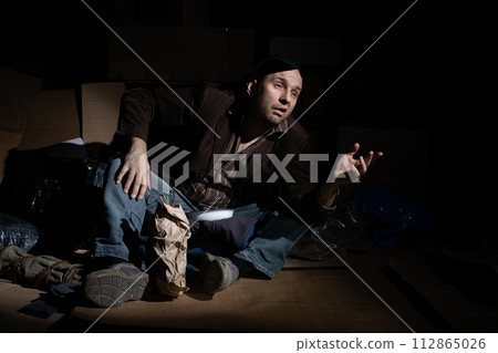 A homeless person asks for small money to improve his situation. A homeless person asks for small money to improve his situation. 112865026