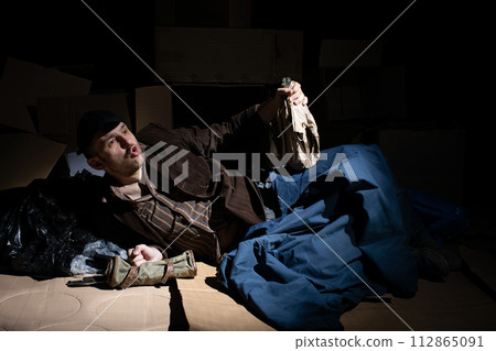A middle-aged homeless man became alcoholic because of his situation. A middle-aged homeless man became alcoholic because of his situation. 112865091