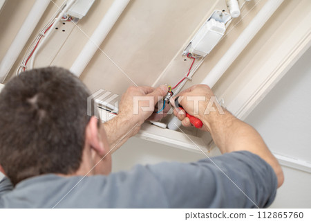 The profession of electrician is one of the most demanding and responsible professions of a construction worker. 112865760