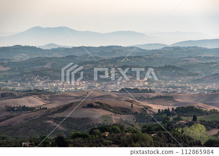 Typical Tuscan landscape with hills and cypresses in the very early morning near Montaione 112865984