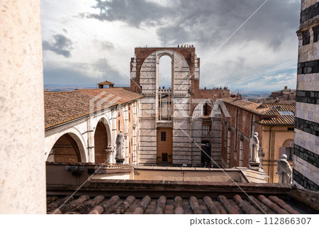 Unfinished transept of the planned enlarged cathedral in Siena, seen from the roof of the cathedral 112866307