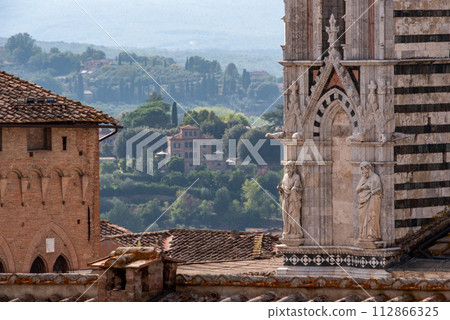 Facade decoration at the portal of the Siena cathedral, seen from the Facciatone panoramic viewpoint Facade decoration at the portal of the Siena cathedral, seen from the Facciatone panoramic viewpoint 112866325