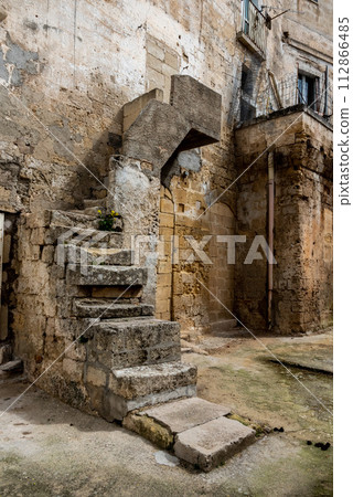 An old damaged staircase in downtown Gravina, Italy 112866485