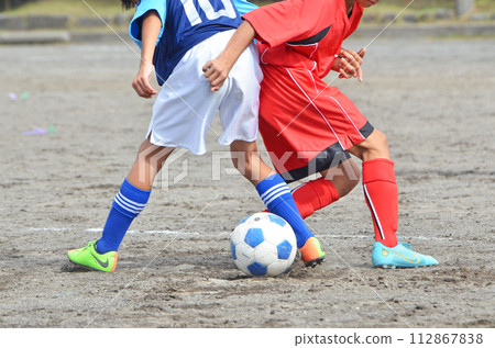 Youth soccer match (players competing for the ball) Youth soccer match (players competing for the ball) 112867838