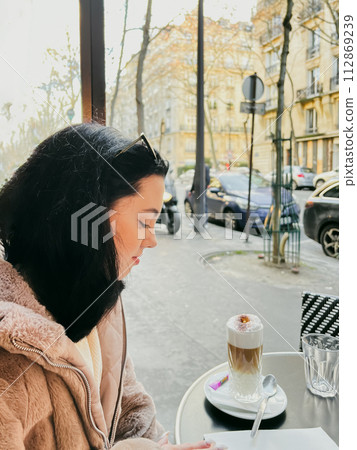 Coffee with ice cream and whipped cream on the table in Paris, France. French toast with ice cream and caramelized bananas on a plate. 112869239