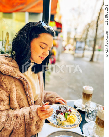 Coffee with ice cream and whipped cream on the table in Paris, France. French toast with ice cream and caramelized bananas on a plate. Coffee with ice cream and whipped cream on the table in Paris, France. French toast with ice cream and caramelized bananas on a plate. 112869251