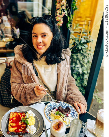 Coffee with ice cream and whipped cream on the table in Paris, France. French toast with ice cream and caramelized bananas on a plate. 112869255
