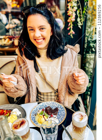 Coffee with ice cream and whipped cream on the table in Paris, France. French toast with ice cream and caramelized bananas on a plate. Coffee with ice cream and whipped cream on the table in Paris, France. French toast with ice cream and caramelized bananas on a plate. 112869256