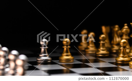 Focused pawn. Silver chess pieces and golden rivals. 112870000