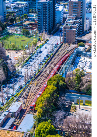Tokyo cityscape in Japan View of the new 2000 series trains of the Tokyo Metro Marunouchi Line running on the ground (Korakuen Station on the lower left) 112870133