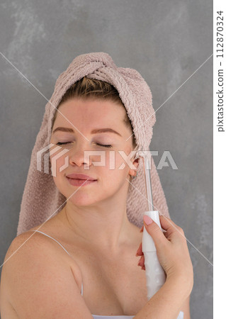 Microcurrent facial massage therapy 112870324