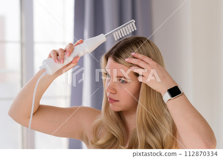 Enjoying microcurrent hair therapy. 112870334