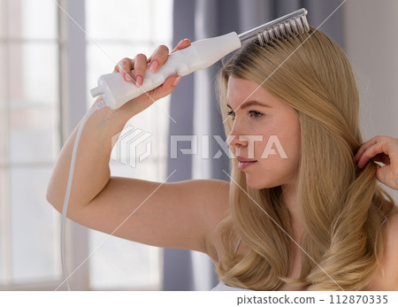 Enjoying microcurrent hair therapy. Enjoying microcurrent hair therapy. 112870335