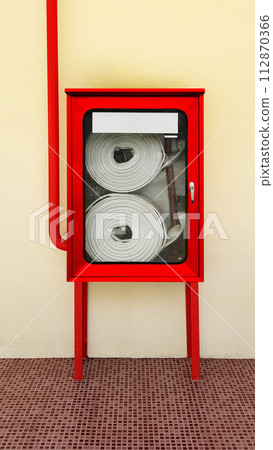 Fire extinguishing system on background wall, powerful emergency equipment for industry Fire extinguishing system on background wall, powerful emergency equipment for industry 112870366