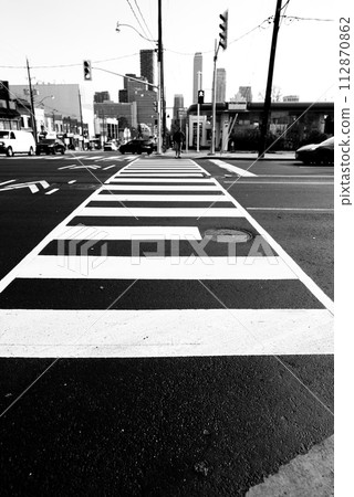black and white photo of pedestrian crosswalk at city road 112870862