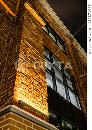 facade of renovated old factory building on night facade of renovated old factory building on night 112871036