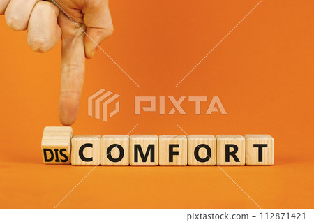 From discomfort to comfort symbol. Concept word Discomfort or Comfort on wooden cubes. Beautiful orange background. Businessman hand. Business and from discomfort to comfort concept. Copy space. From discomfort to comfort symbol. Concept word Discomfort or Comfort on wooden cubes. Beautiful orange background. Businessman hand. Business and from discomfort to comfort concept. Copy space. 112871421