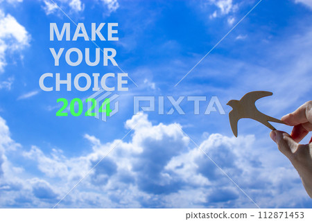 Make your choice 2024 symbol. Concept words Make your choice 2024. Beautiful blue sky cloud background. Voter hand with wooden bird. Business Make your choice 2024 concept. Copy space Make your choice 2024 symbol. Concept words Make your choice 2024. Beautiful blue sky cloud background. Voter hand with wooden bird. Business Make your choice 2024 concept. Copy space 112871453