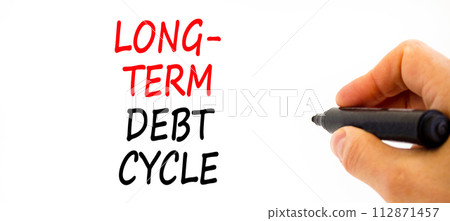 Long-term debt cycle symbol. Concept words Long-term debt cycle on beautiful white paper. Beautiful white background. Voter hand. Business Long-term debt cycle concept. Copy space. 112871457