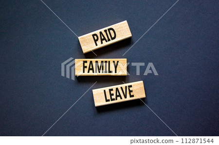 Paid family leave symbol. Concept words Paid family leave on wooden blocks. Beautiful black table black background. Business medical and paid family leave concept. Copy space. 112871544