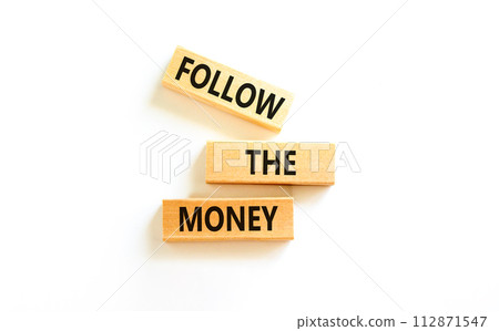 Follow the money symbol. Concept words Follow the money on beautiful wooden blocks. Beautiful white table white background. Business and follow the money concept. Copy space. 112871547
