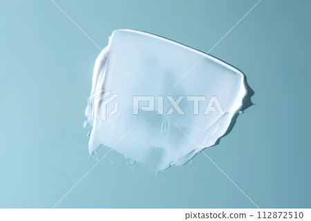 Stroke of white cream on a blue background. 112872510