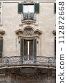 Windows of Rome. Classic old wooden windows with shutters in a public place on a city street or in an urban environment. 112872668