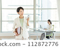 Business woman with a smartphone in the office 112872776