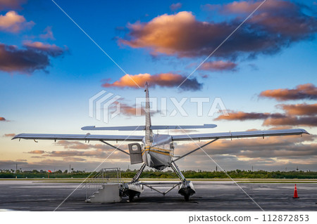 Small seaplane on private airport tarmac in the evening sun Small seaplane on private airport tarmac in the evening sun 112872853