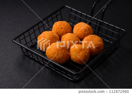 Delicious  balls of mozzarella and parmesan cheese with salt and spices 112872980