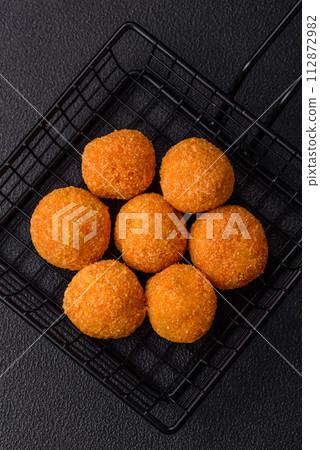 Delicious  balls of mozzarella and parmesan cheese with salt and spices 112872982