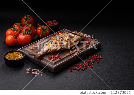 Delicious dorado baked on the grill with salt, spices and herbs 112873035