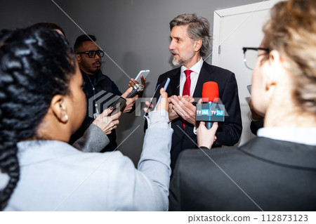 Busy politician answers press questions and gives interview Busy politician answers press questions and gives interview 112873123