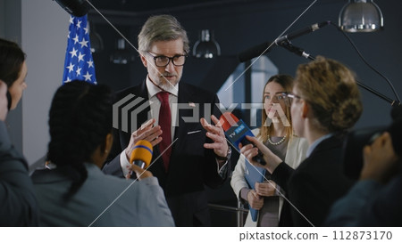 American politician talks with journalists, gives interview for media and television news American politician talks with journalists, gives interview for media and television news 112873170