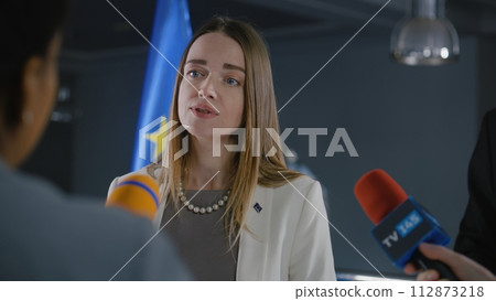 Female Representative of the European Union talks to news journalists Female Representative of the European Union talks to news journalists 112873218