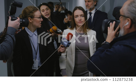 Busy female American minister talks with TV press Busy female American minister talks with TV press 112873238