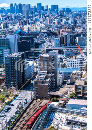 New view of Tokyo cityscape in Japan. Mt.Fuji and Shinjuku. In the foreground is the new Tokyo Metro Marunouchi Line 2000 series train running on the ground. New view of Tokyo cityscape in Japan. Mt.Fuji and Shinjuku. In the foreground is the new Tokyo Metro Marunouchi Line 2000 series train running on the ground. 112873252