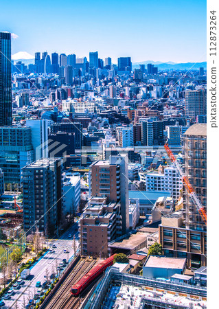 New view of Tokyo cityscape in Japan. Mt.Fuji and Shinjuku. In the foreground is the new Tokyo Metro Marunouchi Line 2000 series train running on the ground. New view of Tokyo cityscape in Japan. Mt.Fuji and Shinjuku. In the foreground is the new Tokyo Metro Marunouchi Line 2000 series train running on the ground. 112873264