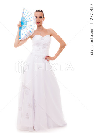 Full length bride in wedding gown holds fan isolated Full length bride in wedding gown holds fan isolated 112873439