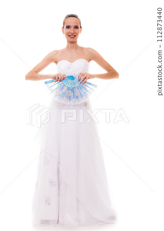 Full length bride in wedding gown holds fan isolated Full length bride in wedding gown holds fan isolated 112873440