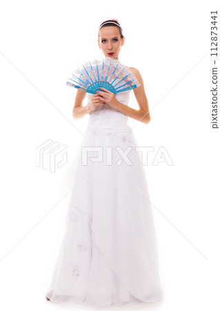 Full length bride in wedding gown holds fan isolated Full length bride in wedding gown holds fan isolated 112873441