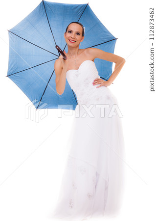 Full length bride in wedding gown holds umbrella Full length bride in wedding gown holds umbrella 112873462