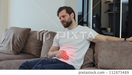 Male having symptom poisoning diarrhea indigestion peptic ulcer pancreatitis at home. 3d animation with red pulsating sore zone of problem area. People health care problem. Male having symptom poisoning diarrhea indigestion peptic ulcer pancreatitis at home. 3d animation with red pulsating sore zone of problem area. People health care problem. 112873489