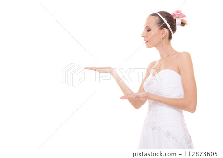 Woman bride in white wedding dress blowing a kiss. 112873605