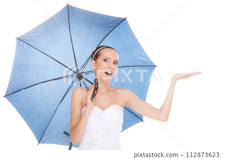 Pretty bride woman in white dress holding umbrella 112873623