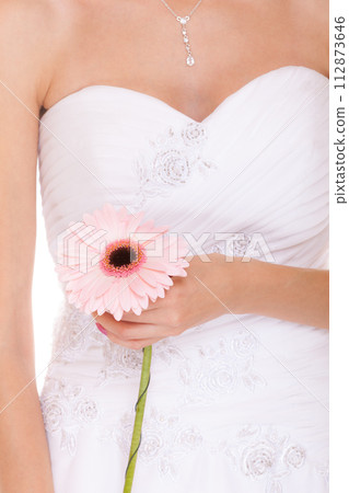 Closeup of bride white wedding dress with flower 112873646