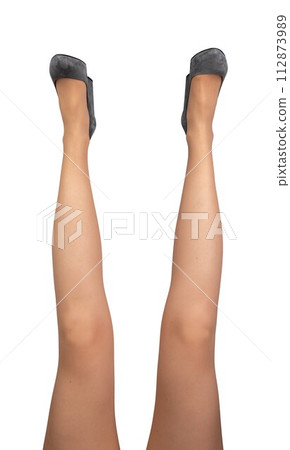 Female legs raised up, funny pose, position, wearing gray heeled shoes isolated on white Female legs raised up, funny pose, position, wearing gray heeled shoes isolated on white 112873989